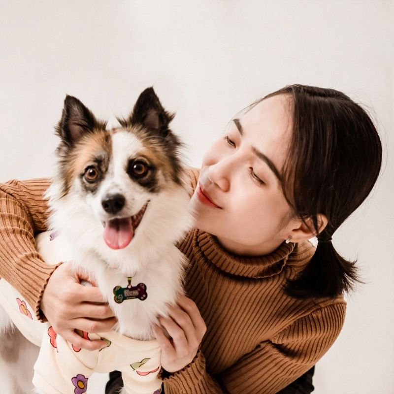 a girl caring a dog