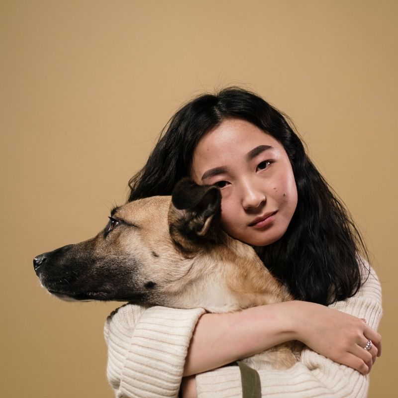girl hugging a dog